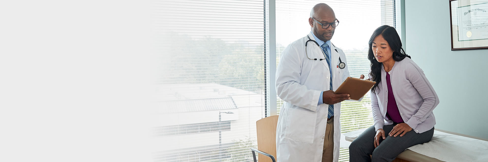 Doctor with patient using tablet