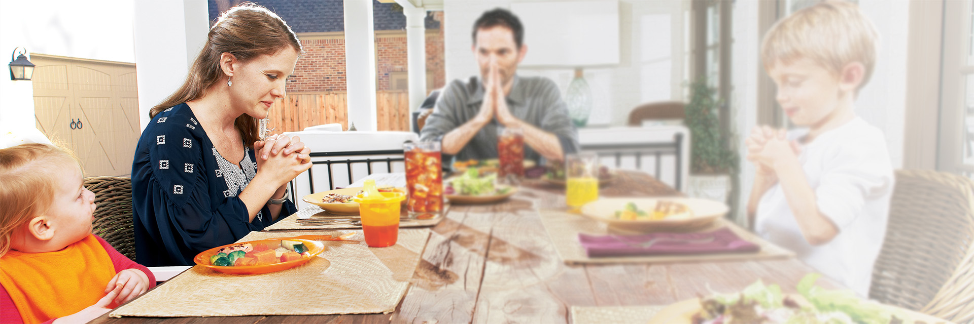 Family Praying Together at Table