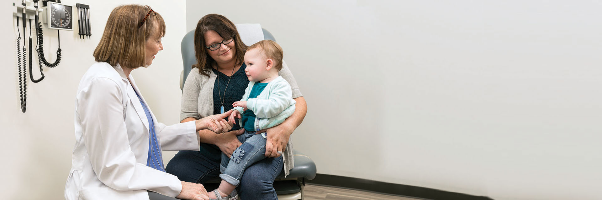 Doctor with baby and mother