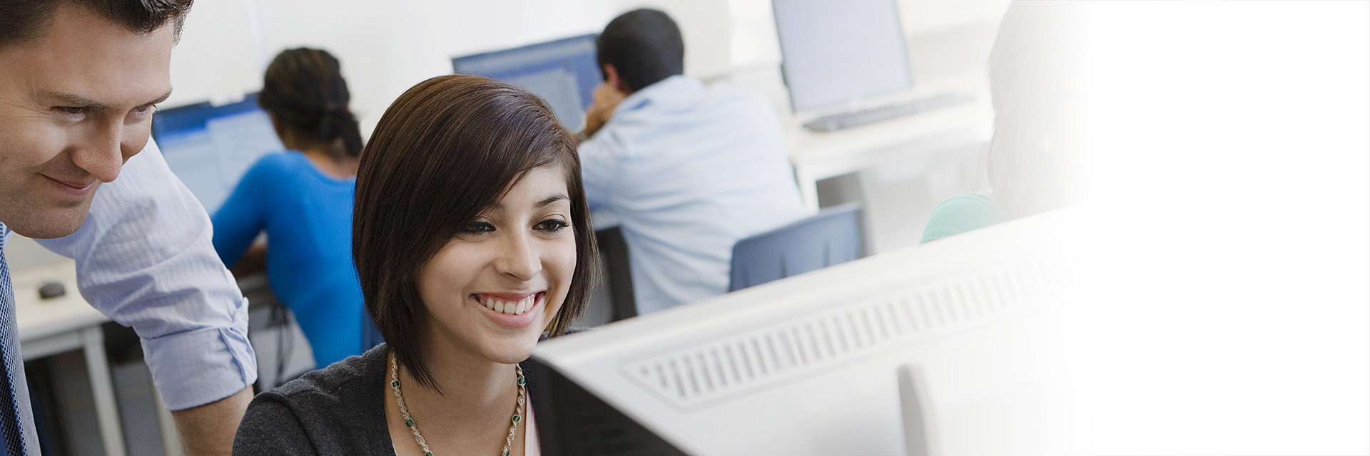 Teacher Helping Student on Computer