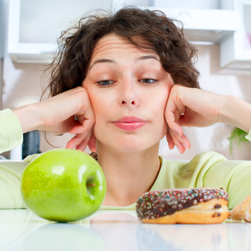 Woman looking at good food and bad food